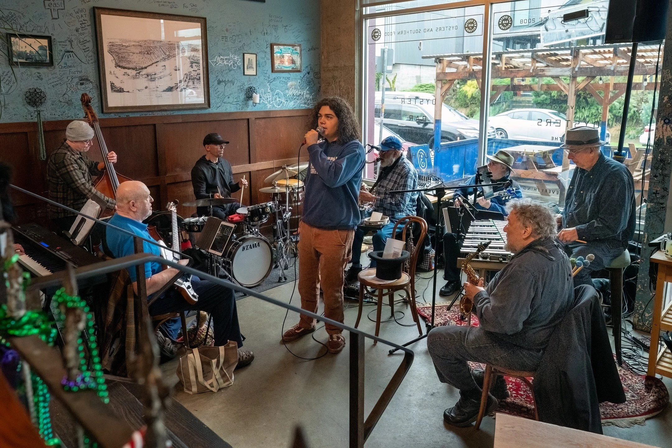 Pablo Henriques, a young singer strutting his stuff with Reggie Houston and his band at EAT Oyster Bar. Reggie's Sunday gigs are well-loved for being a place where young musicians from around the community get a chance to perform with top players. @r