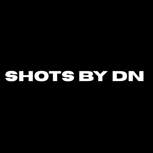 Black background with white text that says 'SHOTS BY DN'.