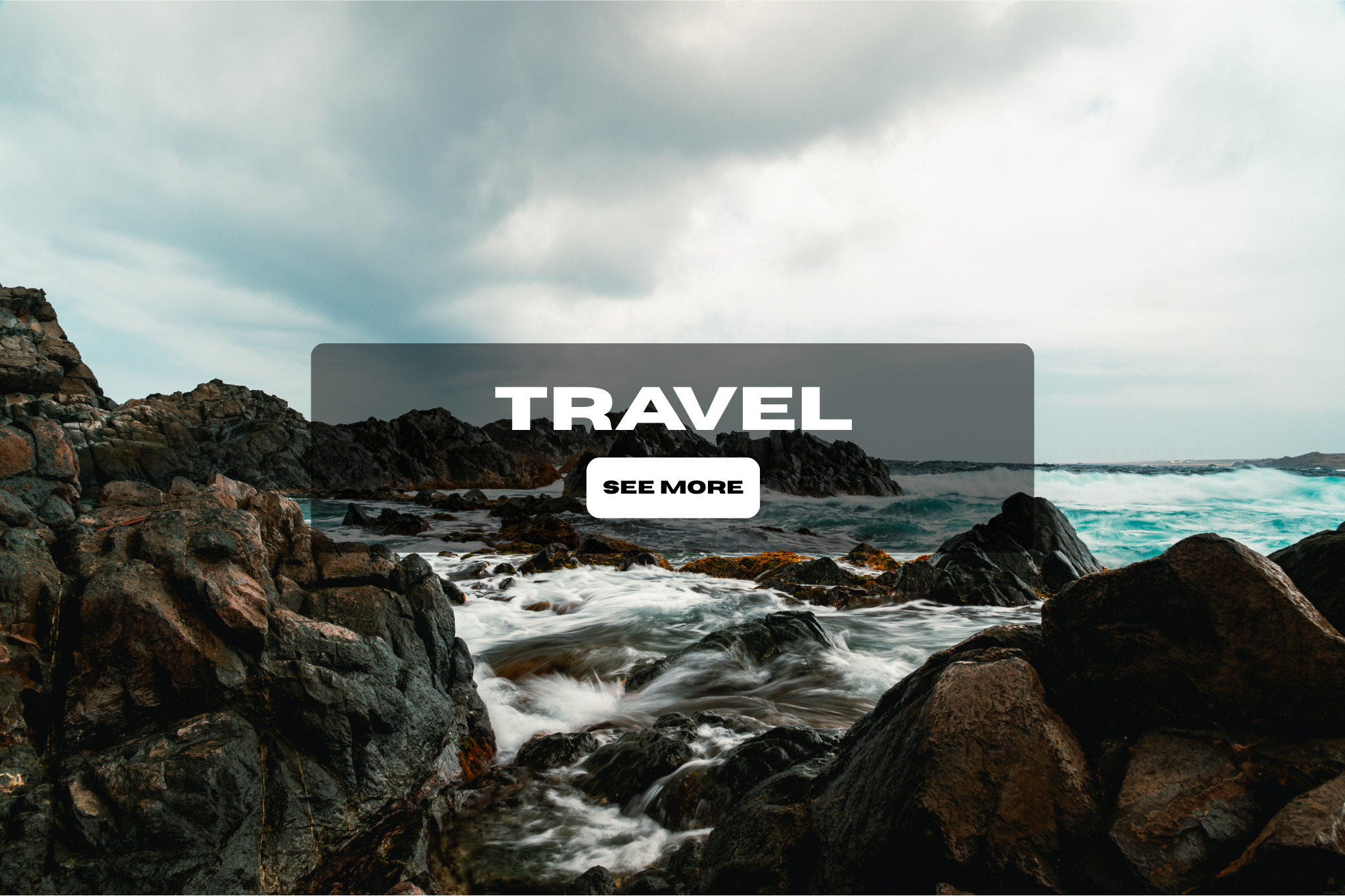Rocky shoreline with waves crashing against rocks under a cloudy sky, promoting travel with a 'See More' button.