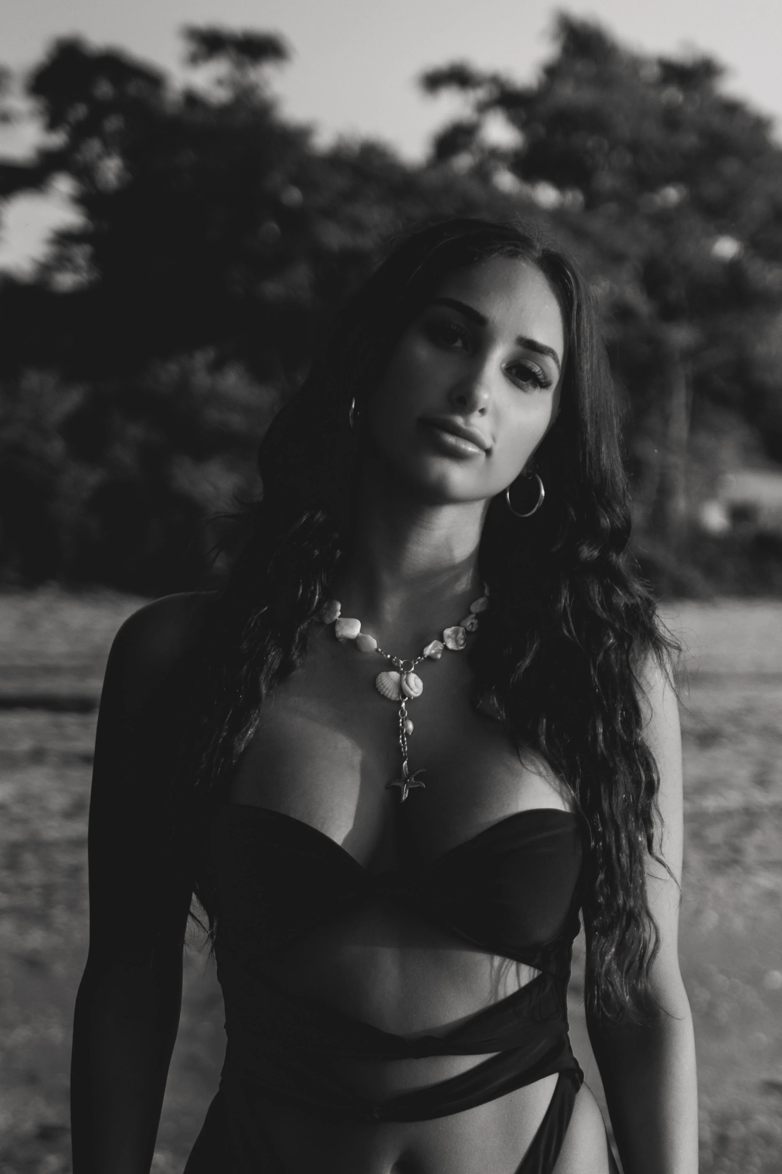 Black-and-white portrait of a woman standing outdoors in soft natural light on long island, new york