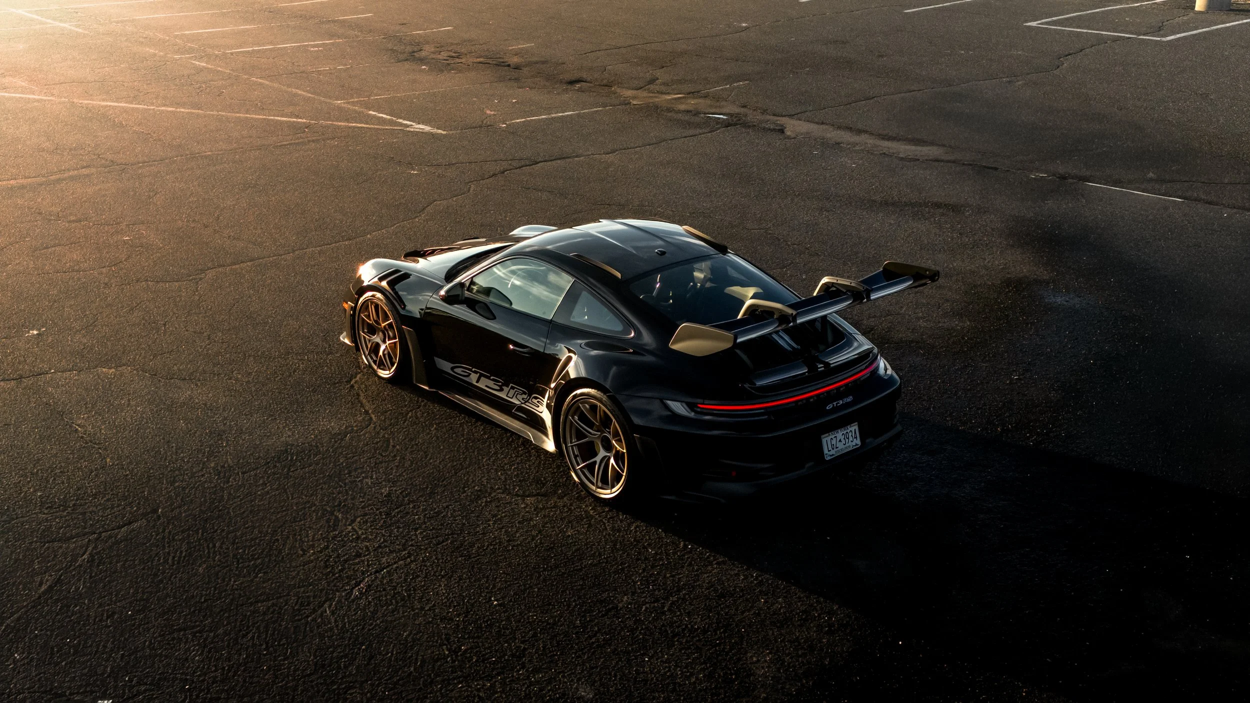 Black Porsche GT3 RS during a cinematic long island sunset