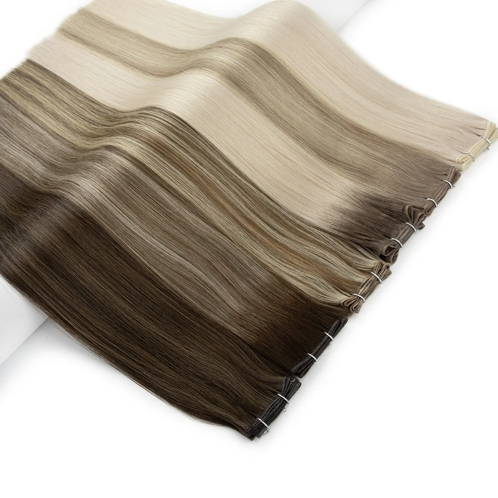 Multiple hair extension swatches in shades from blonde to dark brown, arranged in a gradient on a white background.