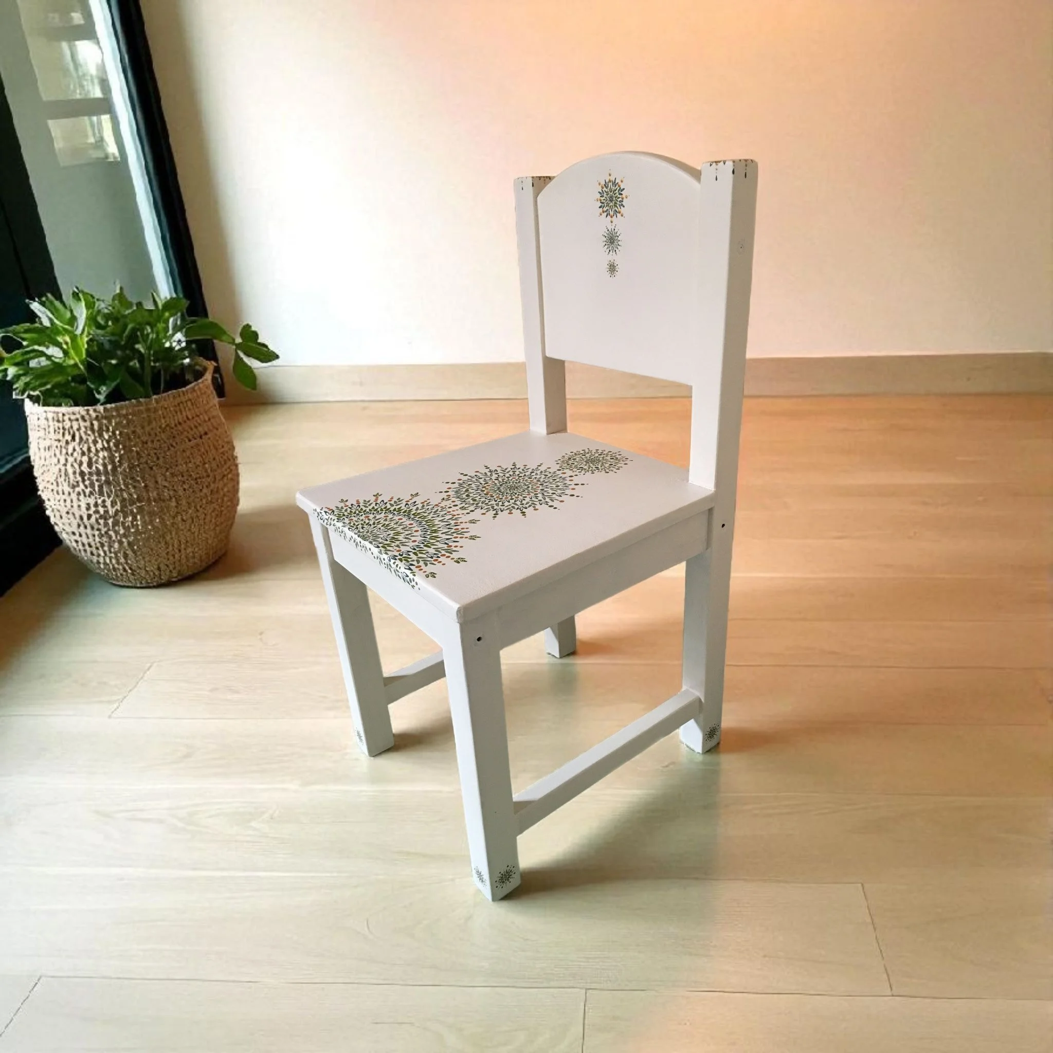 White children's chair with a green mandala