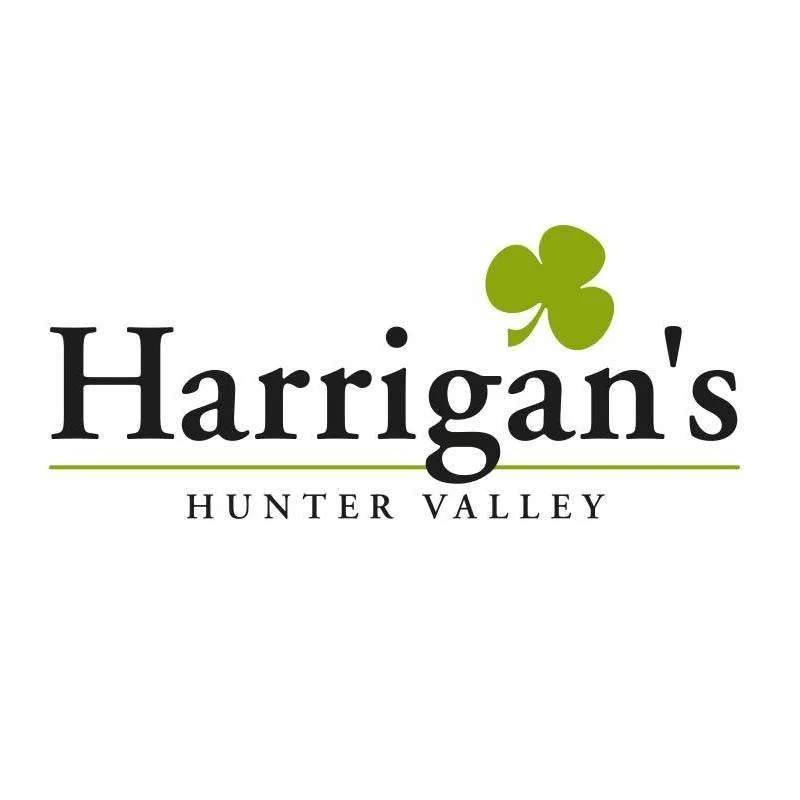 Logo for Harrigan's Hunter Valley with a green shamrock above the text.