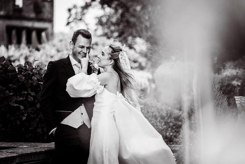 Black & White photo of the bride & groom laughing
