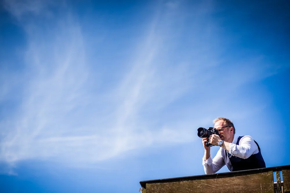 Colour photo of Matt Rock working on top of a roof in Danson Park, Boathouse wedding venue in Bexley
