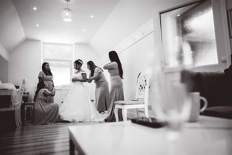 Black and white photo of the bride and her brides maids getting ready at Highley Manor