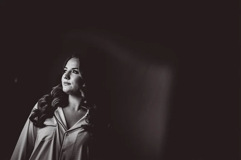 Black & white photo of the reflection of the bride getting ready in Kent