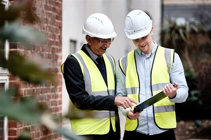 Commercial shoot for a London based surveyors - two surveyors looking at plans outside a building. 