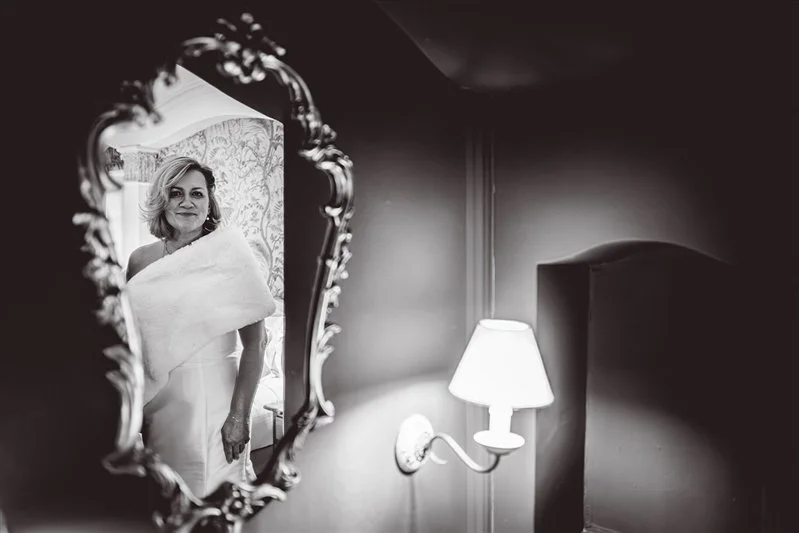 Black & White photo of the brides reflection in the mirror just before walking to the ceremony at Hayne House.