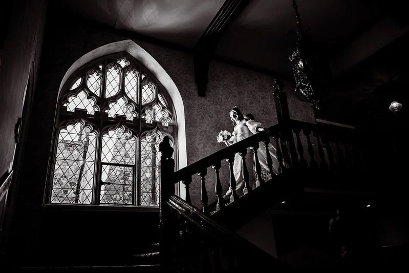 Kat walking down the stairs at Eastwell Manor going to her ceremony at Eastwell Manor, Kent.