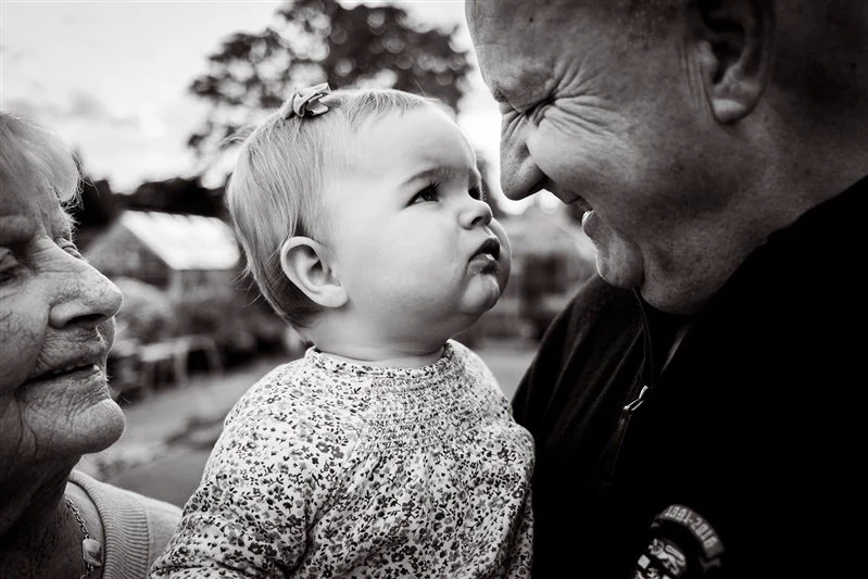 Black & White photo of grandparents with their grandaughter