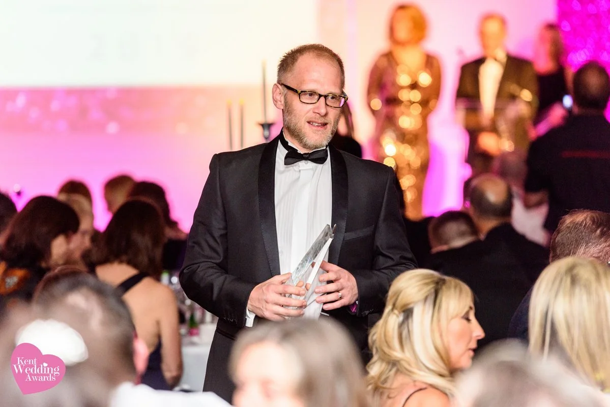 Colour photo of Matt Rock receiving the award for wedding photographer of the year award at The Kent wedding Awards Kent wedding photographer of the year