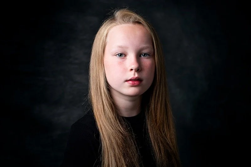 A young girl wearing a black top and long hair  Kent Portrait Photographer Matt Rock