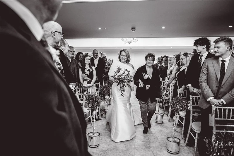 Bride walking with her mum down the aisle at Hayne House, Kent