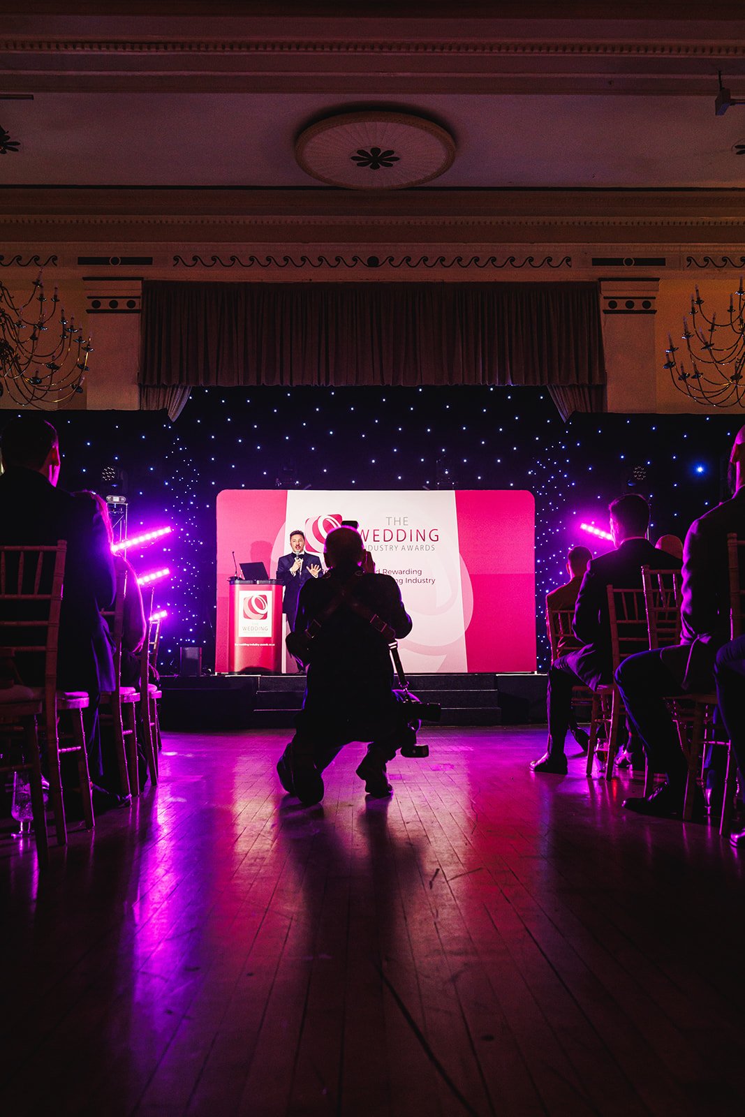 Colour photo of Matt Rock photographing the awards presentation at The Adelphi Hotel, Liverpool