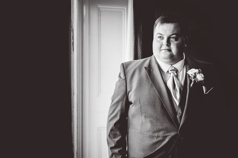 Black & White portrait of the groom in his wedding suit