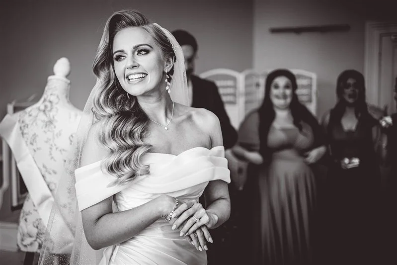 Black & white photo of the bride in her dress as she is getting ready to leave for her ceremony at Salomons Estate. Wedding photographer Kent