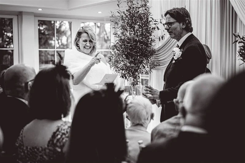 Black & White photo of the bride reading her vows at Hayne House, Kent