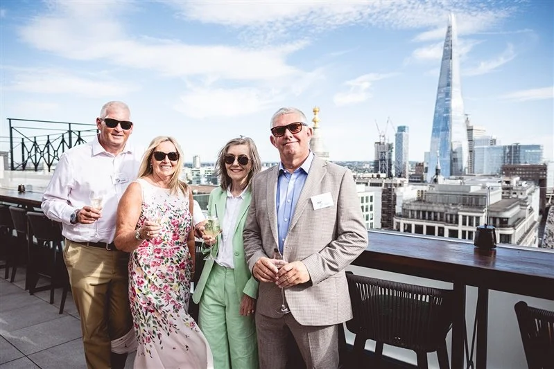 Colour photo on top of the Wagtail Rooftop Bar & Restaurant of the people in charge of SEC with the Shard in the background.