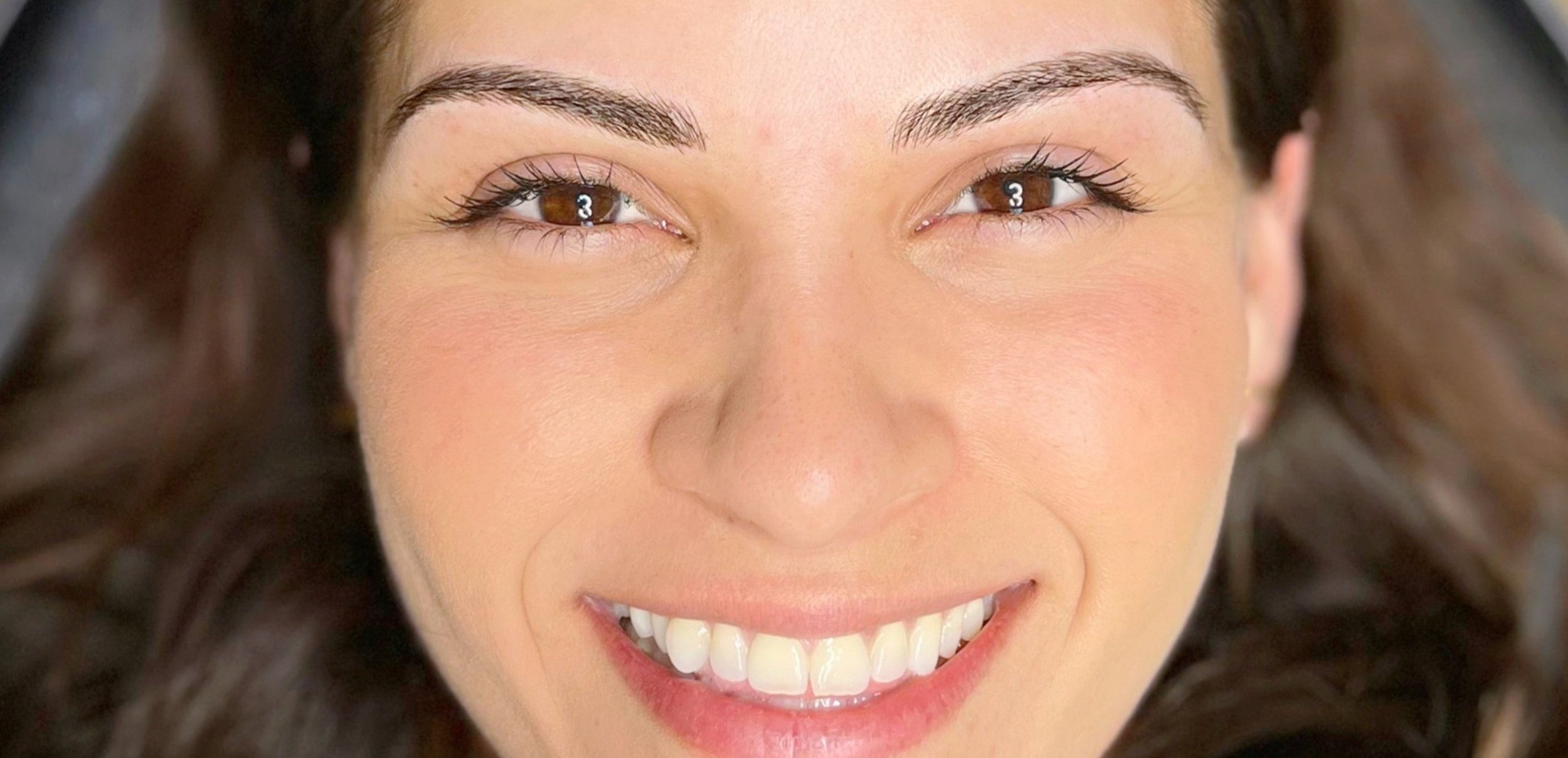 Client after first microblading session, thrilled with how natural her new brows look.