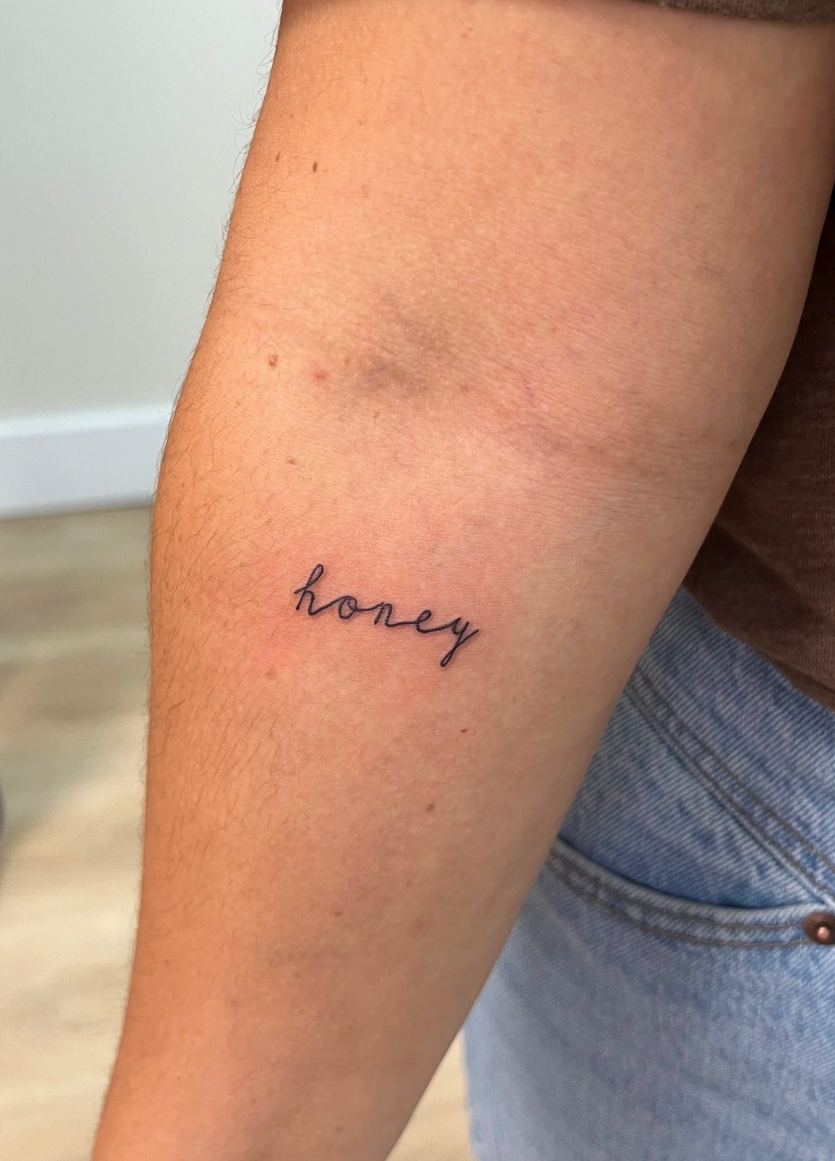 fine line word tattoo, script tattoo