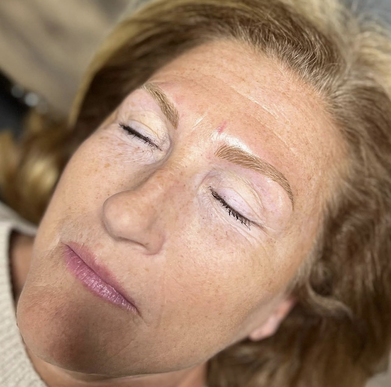 Subtle microblading on light skin with auburn hair for a soft, natural finish.