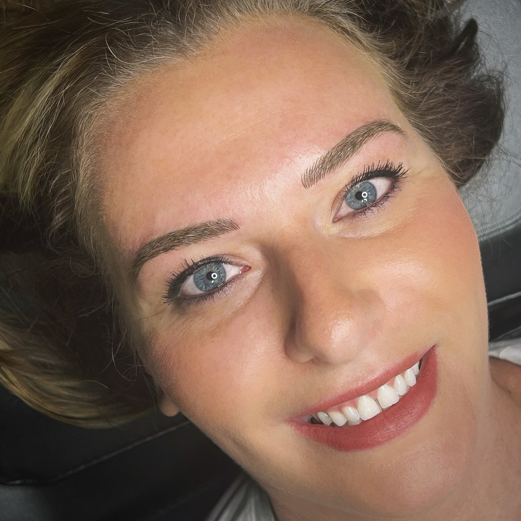 Healed microblading results showing natural-looking hair strokes on sparse brows.