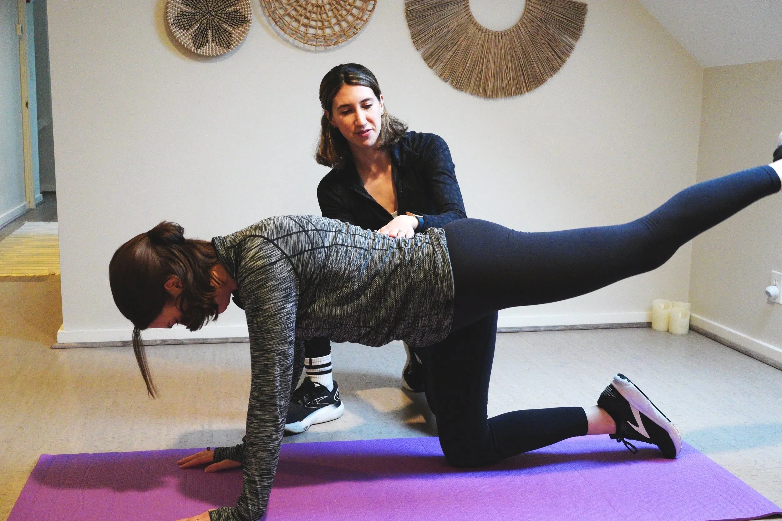 Woman doing pelvic floor core exercise with cueing for form