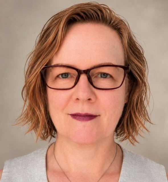 Professional woman with brown hair and glasses