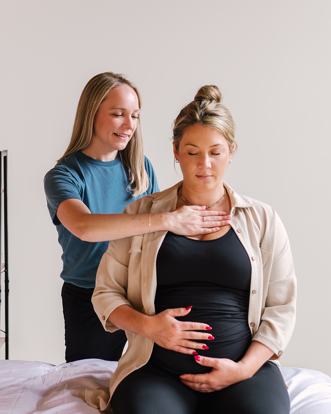 A pregnant woman receiving a specialized care from an expert pelvic floor therapist in a clinical setting.