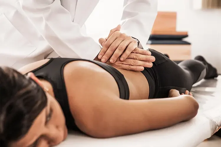 Chiropractor adjusting patient's low back