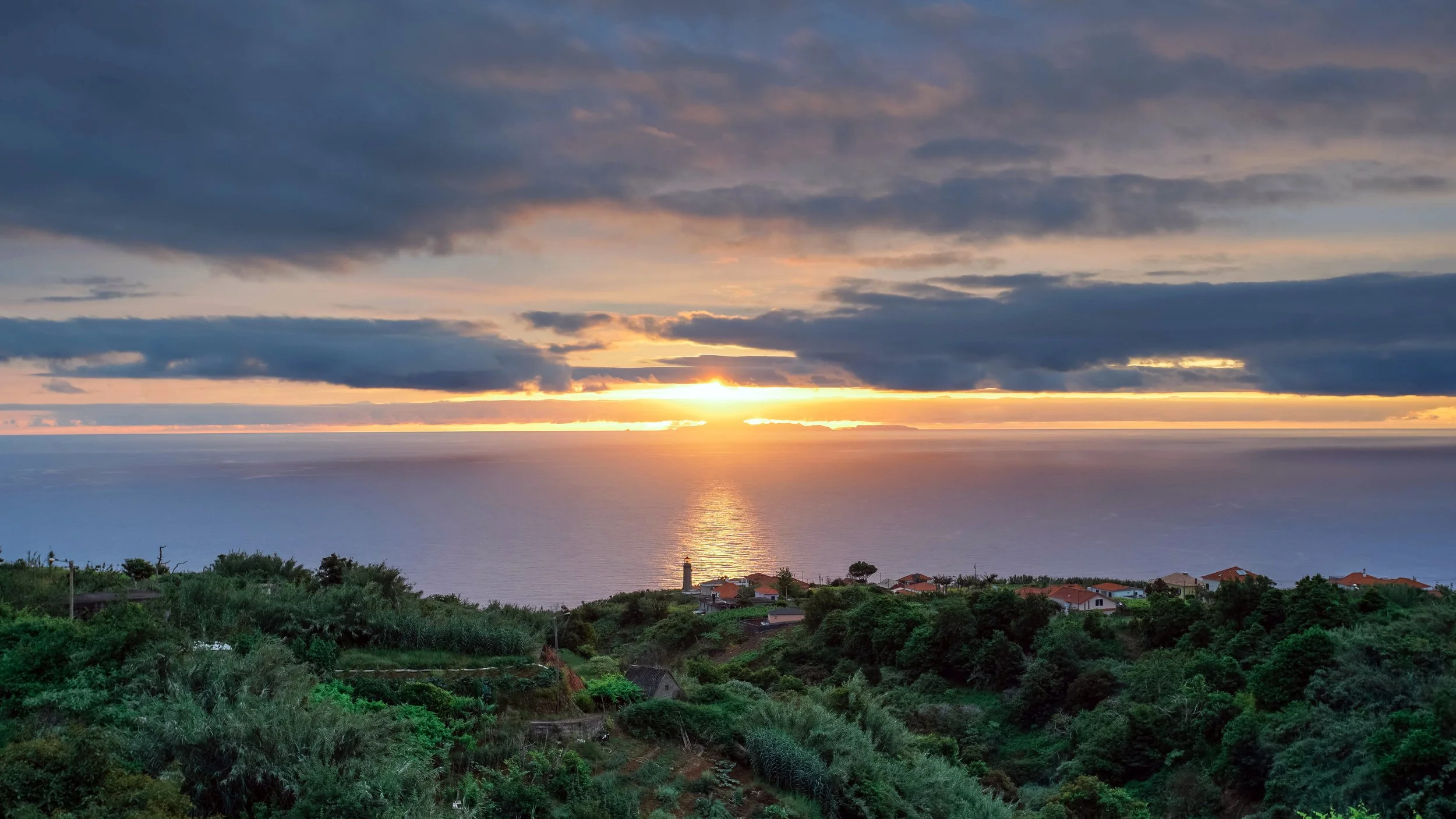 Sunrise overlooking lighthouse near Santana in Madeira