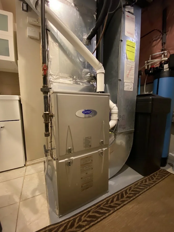 HVAC furnace and ductwork in a basement utility room.