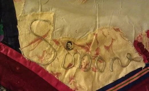 Photo of upclose detail of quilt made by Shulamith Firestone includes image and name of Simone de Beauvoir
