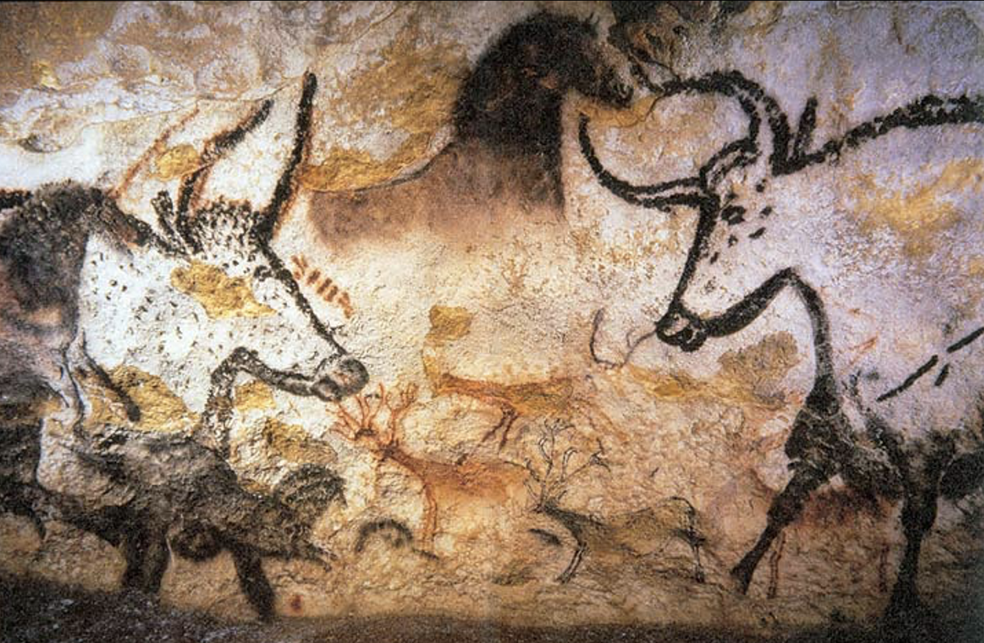 Ancient cave paintings depicting a person riding a horse, with a dog or similar animal nearby, in a primitive art style with black and red pigments.