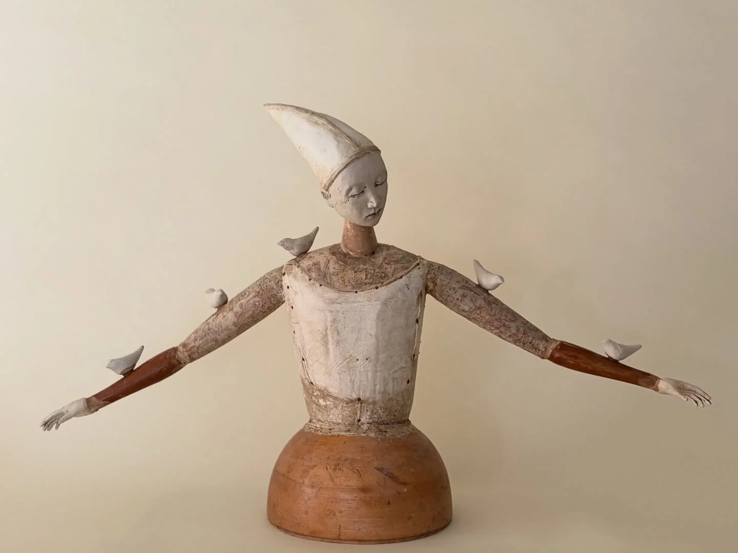 Fragility and strength, held in the same form. A language New Orleans artist Cathy Rose has spent decades refining.

"Eclipse" 
17&times;29&times;7 inches, pedestal piece.
Formed clay, altered wood, antique fabrics and leather, and an antiq