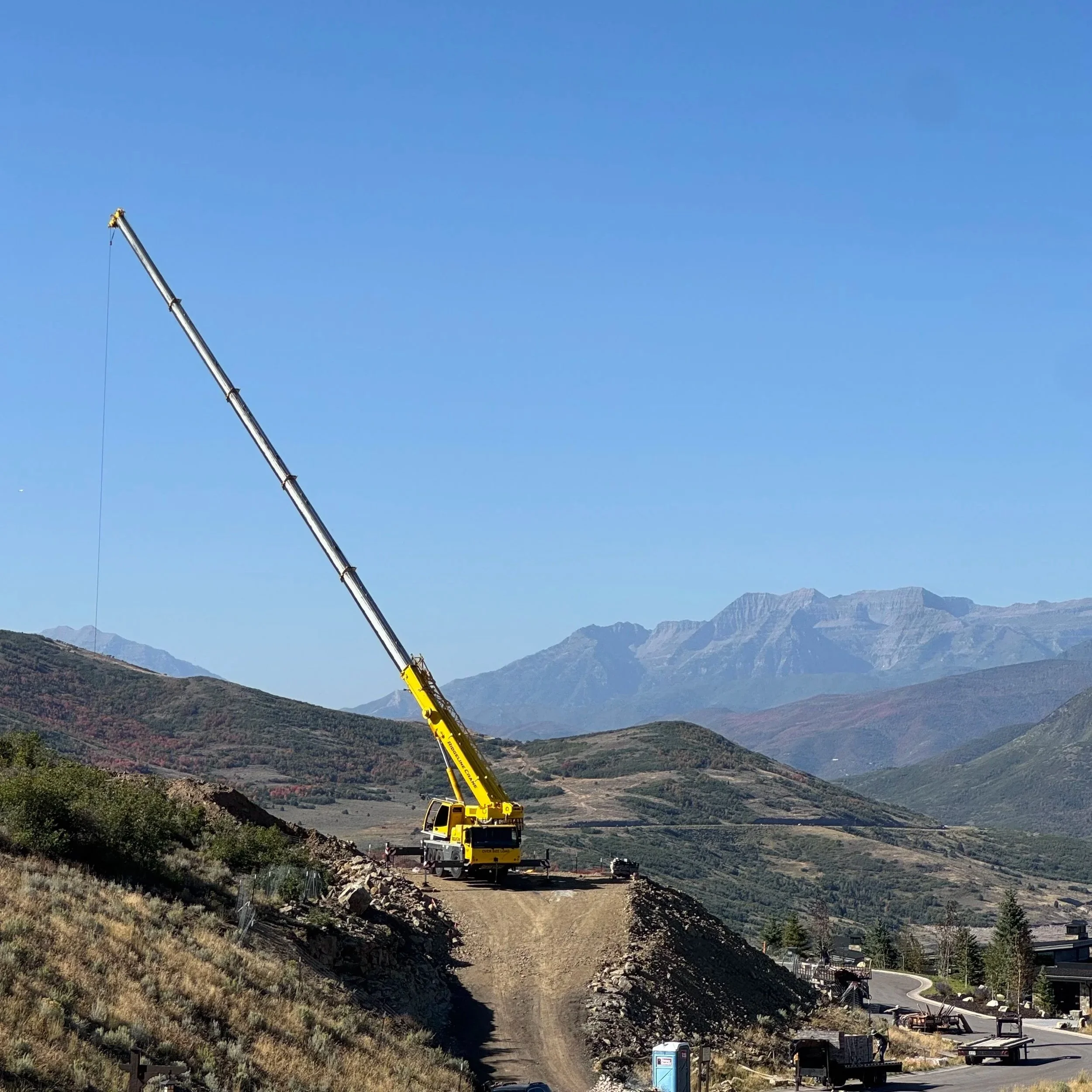 Ridgeline Crane mobile crane service at Park City Utah residential mountain construction site.