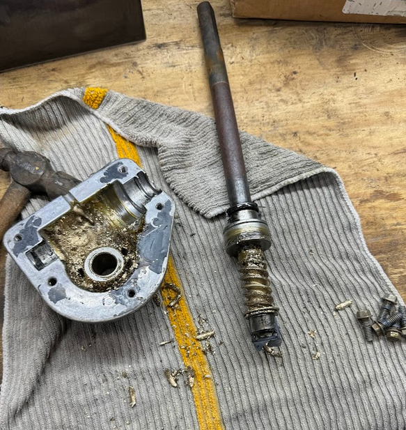 Disassembled 2 or 3-stage snowblower auger gearbox, showing the worm gear all shredded apart inside.
