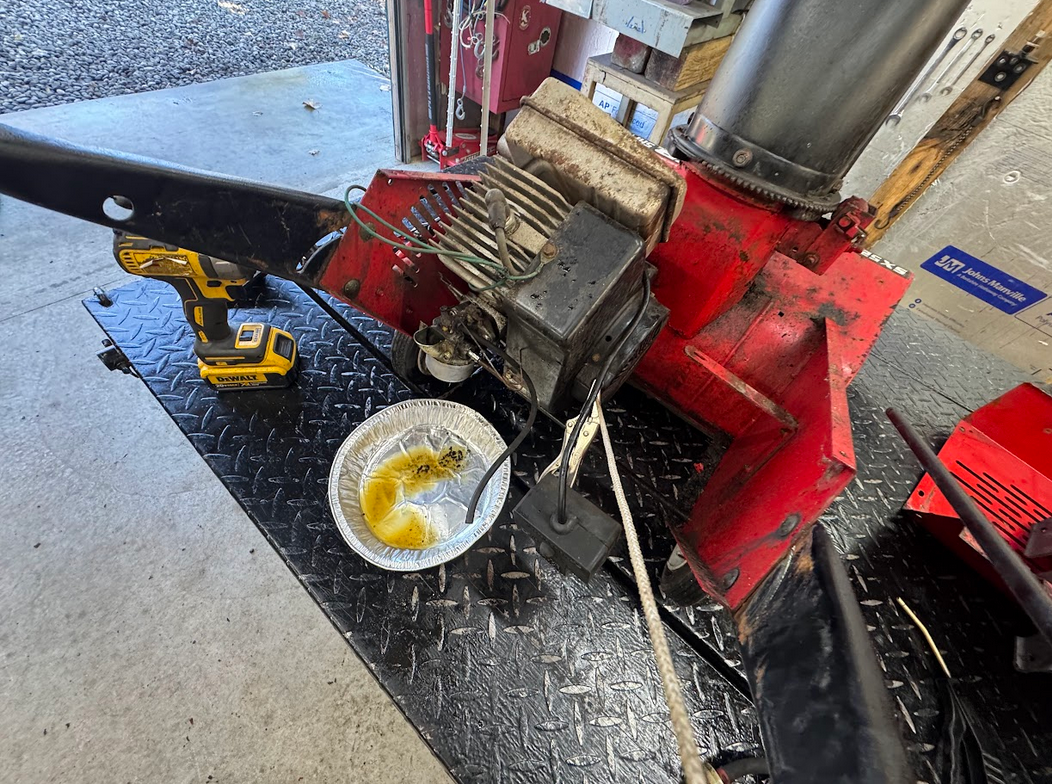 Close-up of a red snowblower with very old gas, bad carburetor.