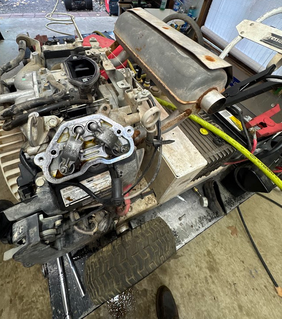 A workbench with an engine undergoing repair.