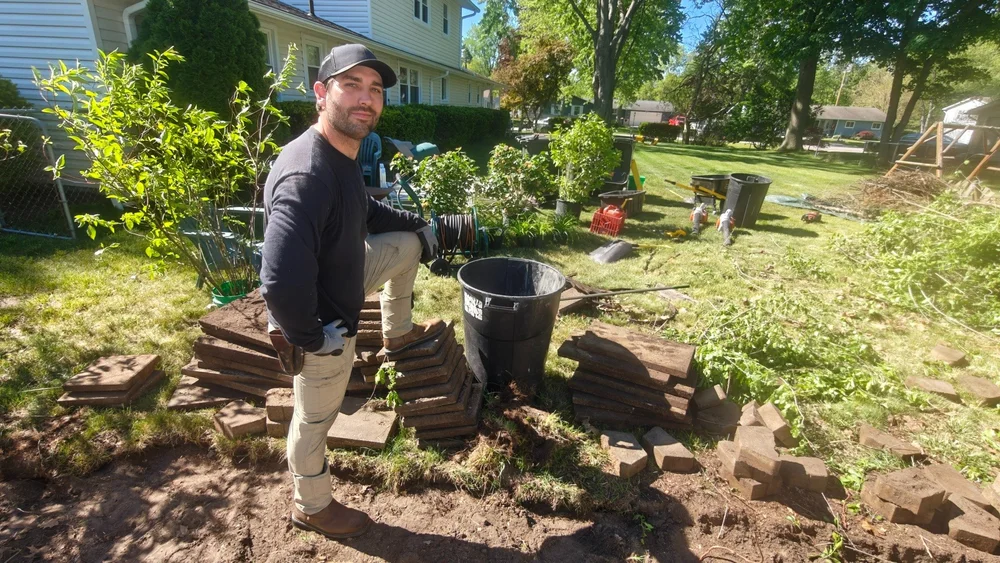 Andre Fleury on a GGL landscape project with plants, pavers, and tools