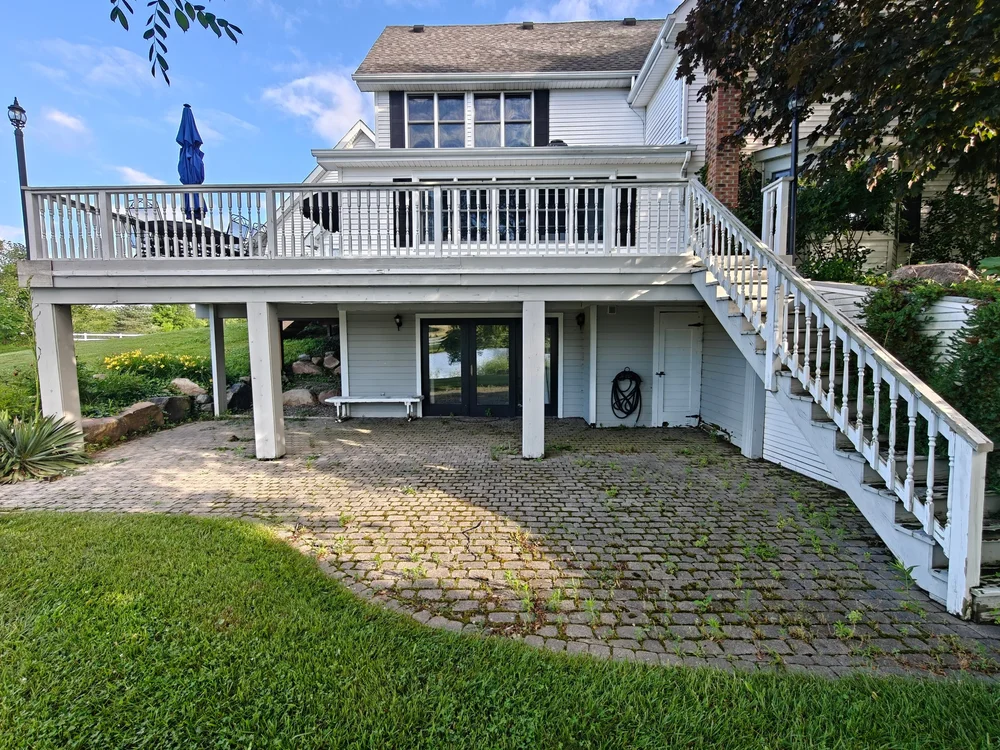 Before GGL paver patio care: surface buildup and vegetation between patio joints