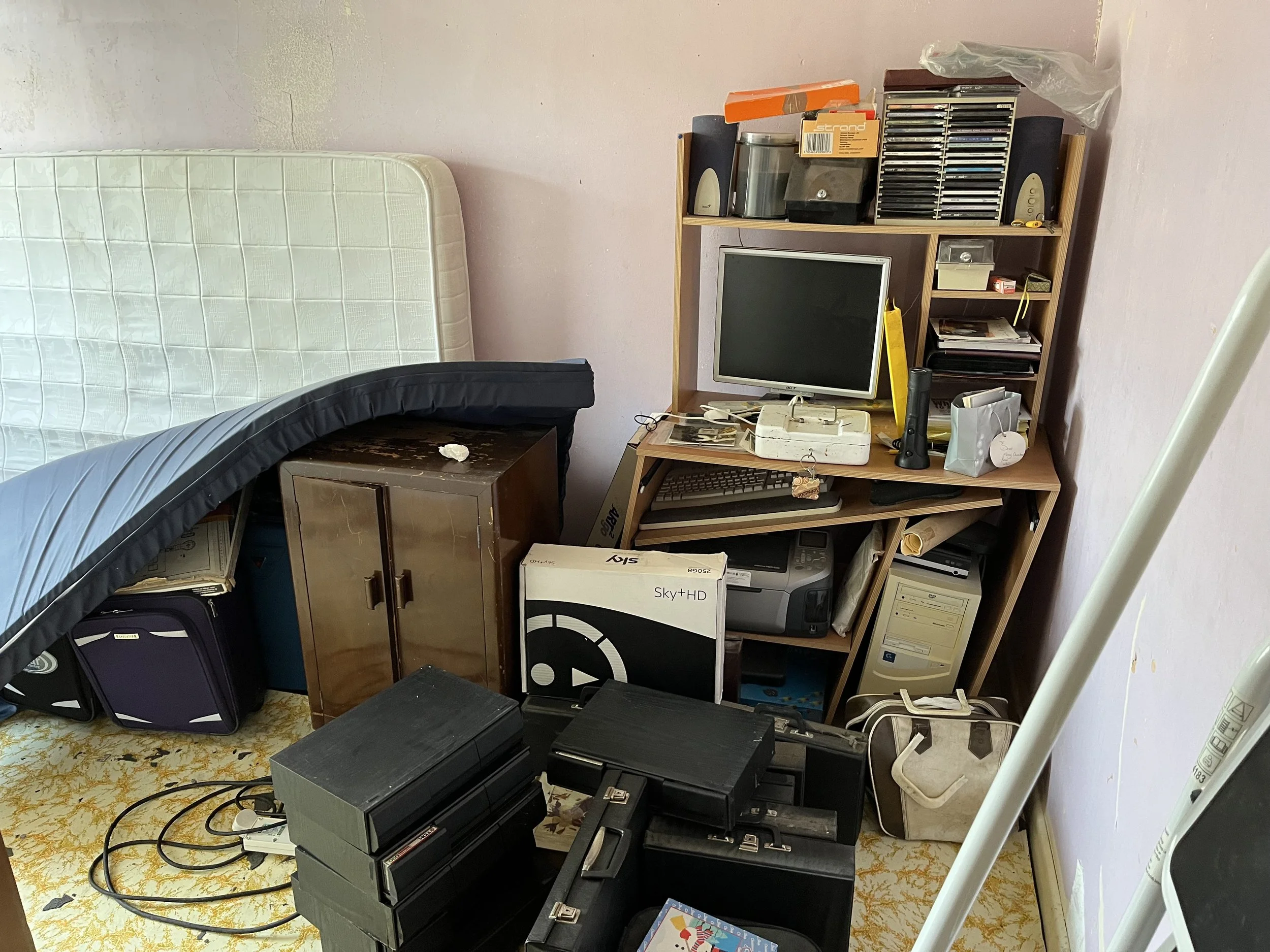 Probate house clearance in Staffordshire and Derbyshire showing cluttered bedroom with mattress, furniture, and old electronics ready for clearance and disposal