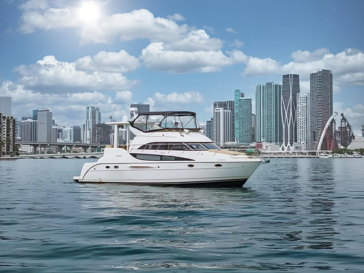 A white yacht on calm water with a city skyline and skyscrapers in the background under a partly cloudy sky.