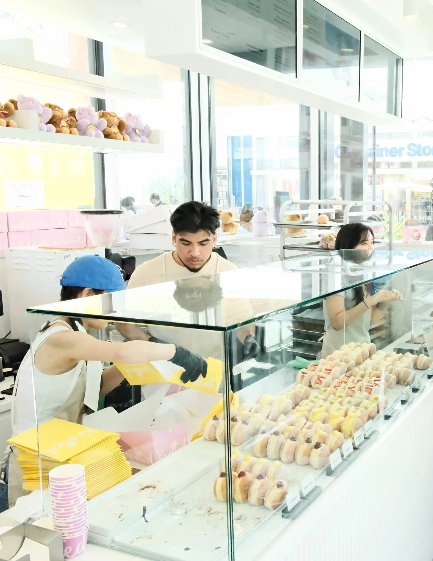 Cafe Knotted staff preparing fresh cream-filled donuts at the Westfield Century City location