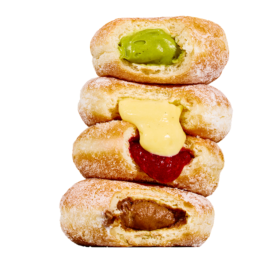Stack of four custard-filled donuts with colorful fillings of green, yellow, red, and brown.