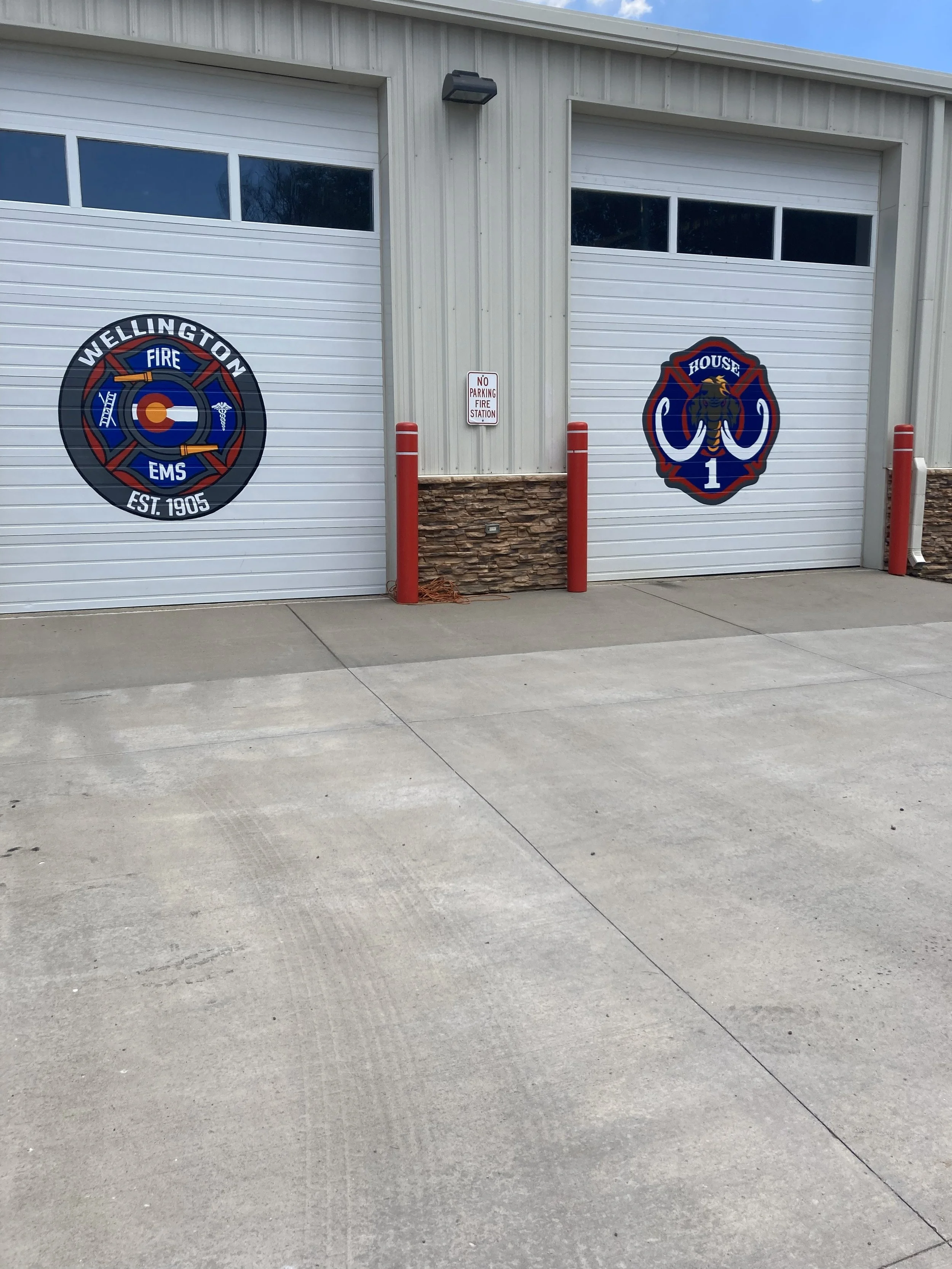 Wellington Fire Department, 2025, exterior acrylic paint on corrugated metal, 12' x 12' doors, commissioned by the City of Wellington