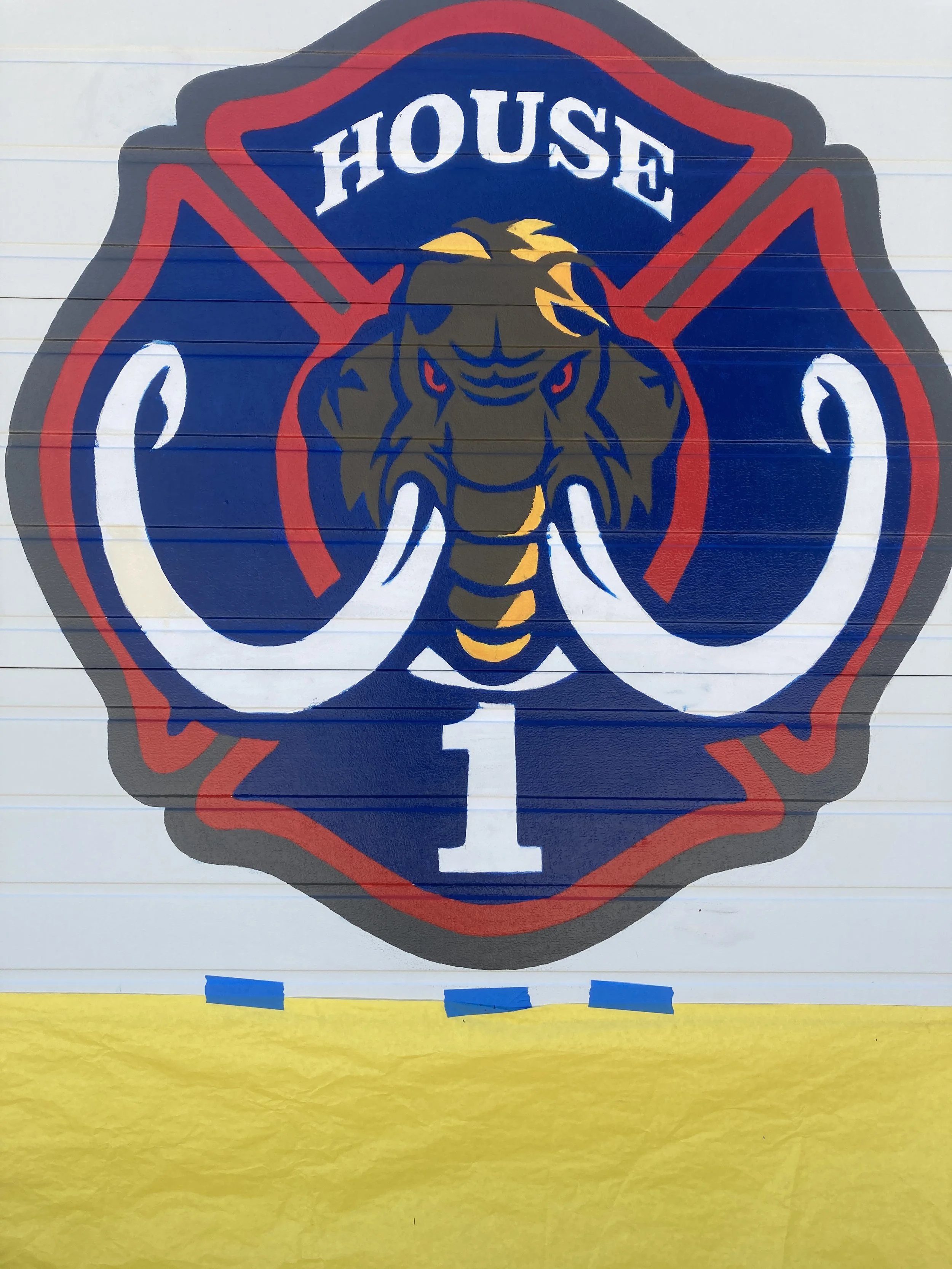 Detail of Wellington Fire Department, 2025, exterior acrylic paint on corrugated metal, 12' x 12' doors, commissioned by the City of Wellington