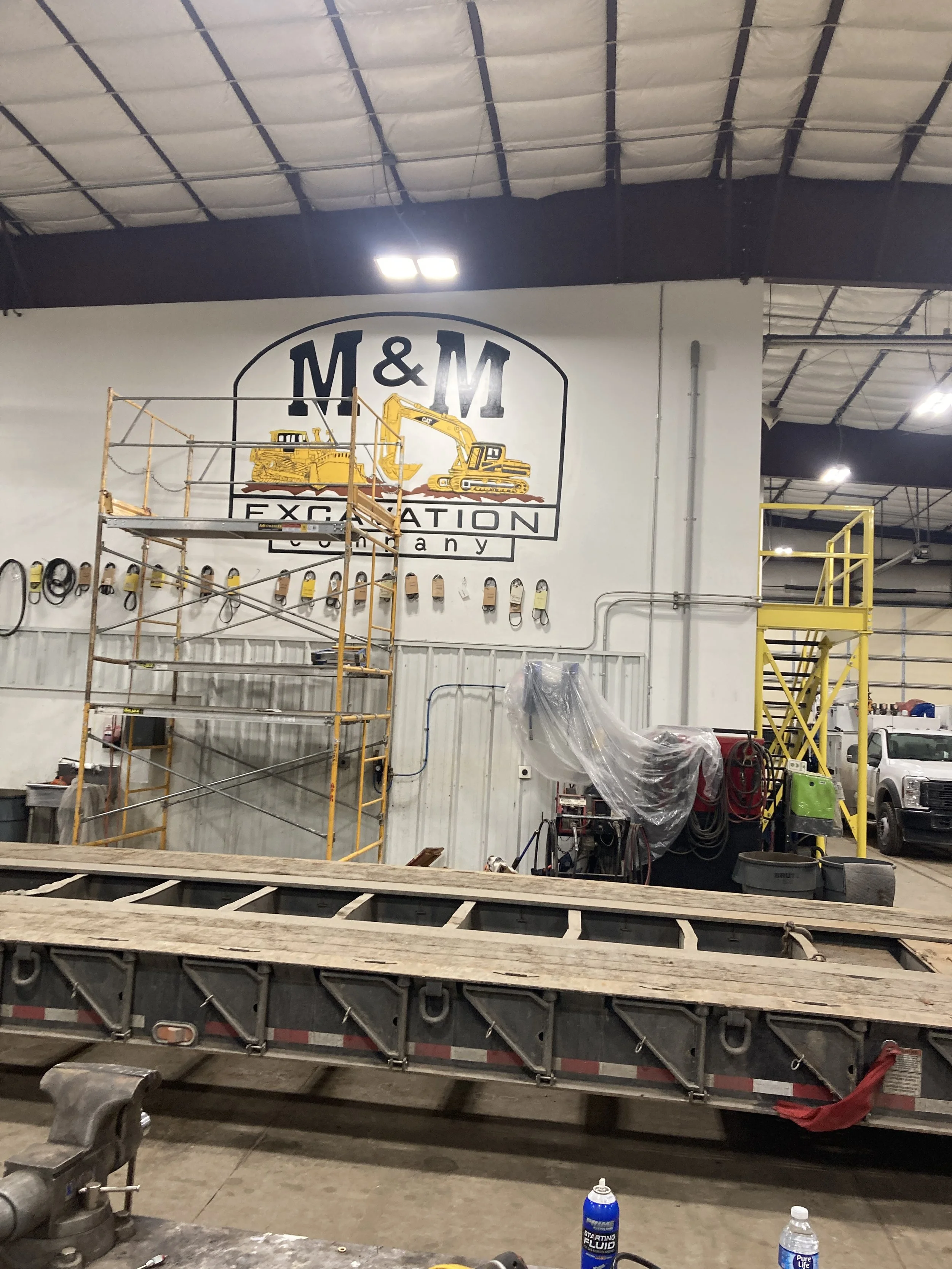 In progress M&M Excavation Co. sign, 2025, 10' x 15', acrylic paint on drywall, located in Kersey, CO. 